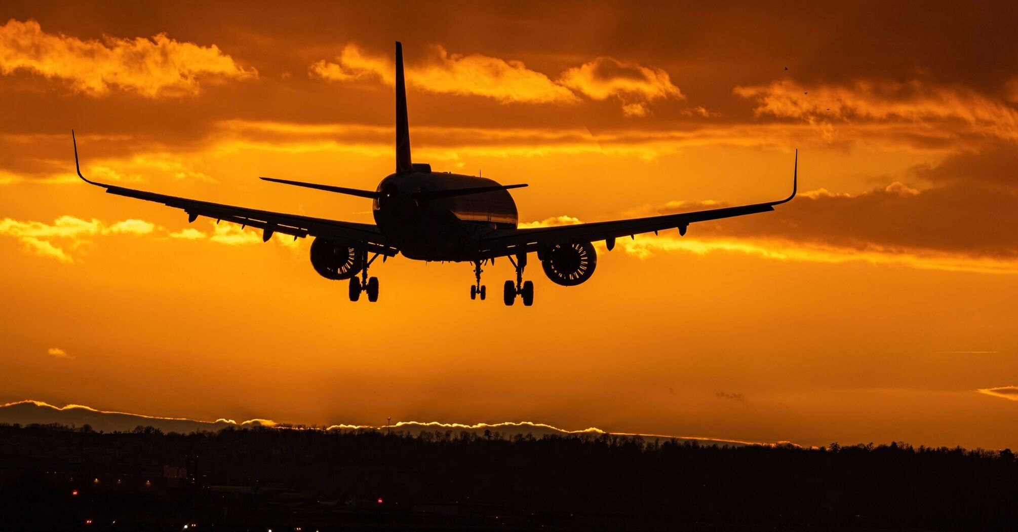 Airplane landing at sunset