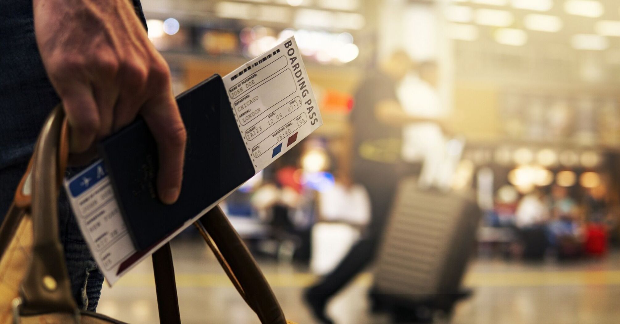 Traveler holding a boarding pass and passport at the airport