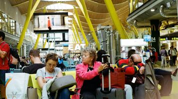 Passengers waiting for their flight at the airport with luggage