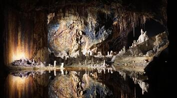 Cave reflections in still water
