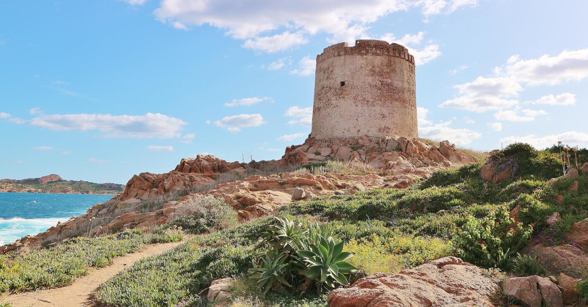 An ancient tower on the Sardinian coast, perched above the rocks and sea