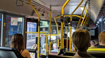 Inside view of a public bus with passengers seated