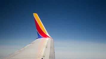 Southwest Airlines wing in flight against a blue sky
