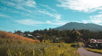 Scenic view of Padang City, West Sumatra, Indonesia with a mountain in the background under a clear blue sky