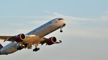 Virgin Atlantic plane taking off against a blue sky