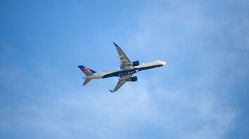 white and blue airplane in the sky