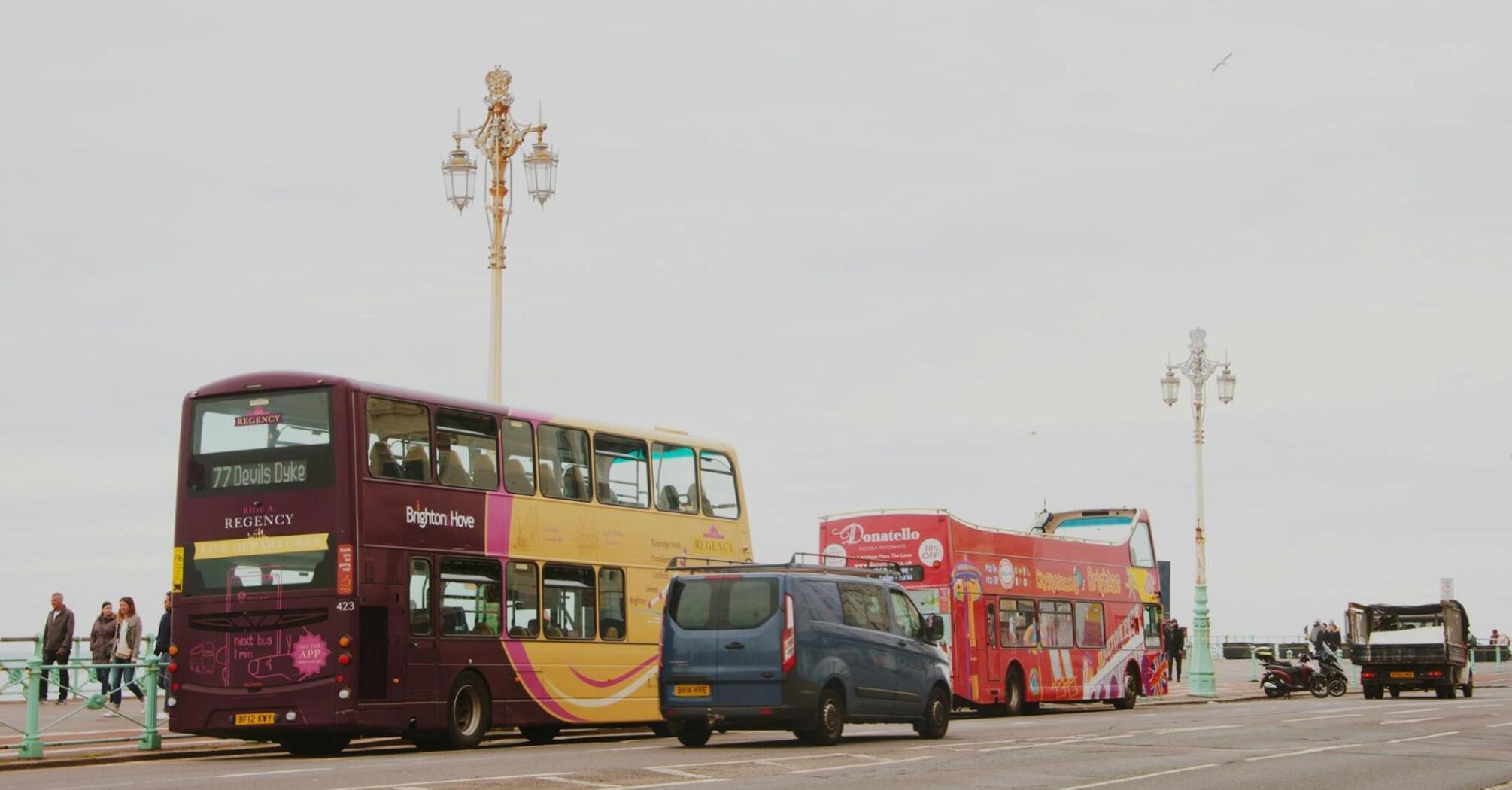 Brighton & Hove buses parked along a street near the seaside