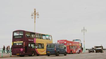 Brighton & Hove buses parked along a street near the seaside