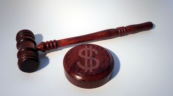 Wooden gavel with dollar sign on the base