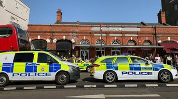 Police and emergency vehicles parked by the road