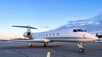 a private jet sitting on the tarmac of an airport