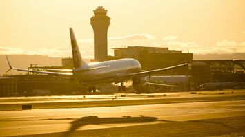 Alaska Airlines plane taking off at sunset
