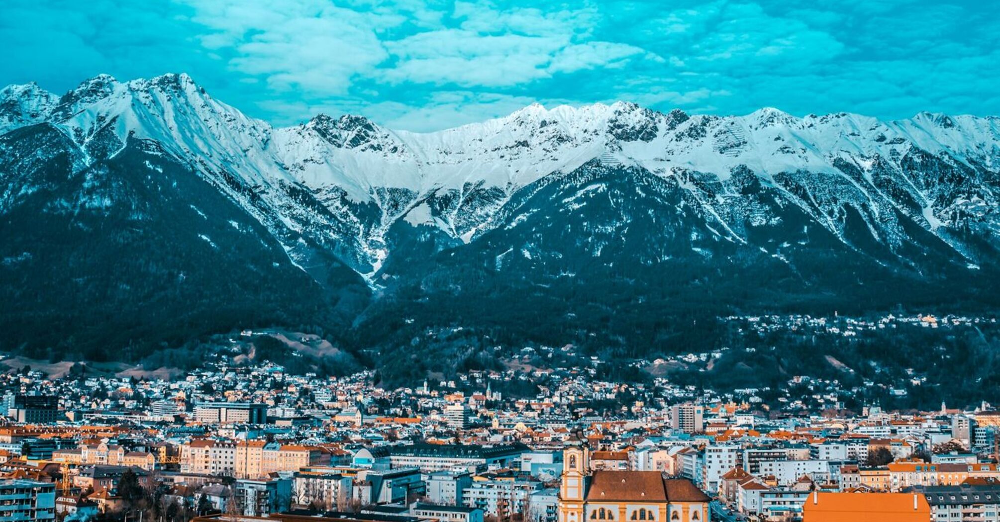 View of Innsbruck with snow-capped mountains in the background
