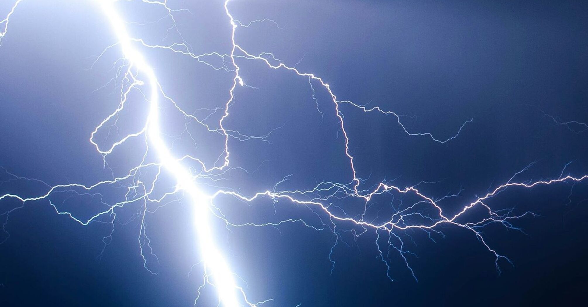 Lightning striking the ground at night