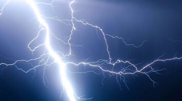 Lightning striking the ground at night