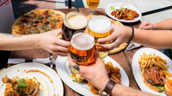 Eating and drinking beer outside together