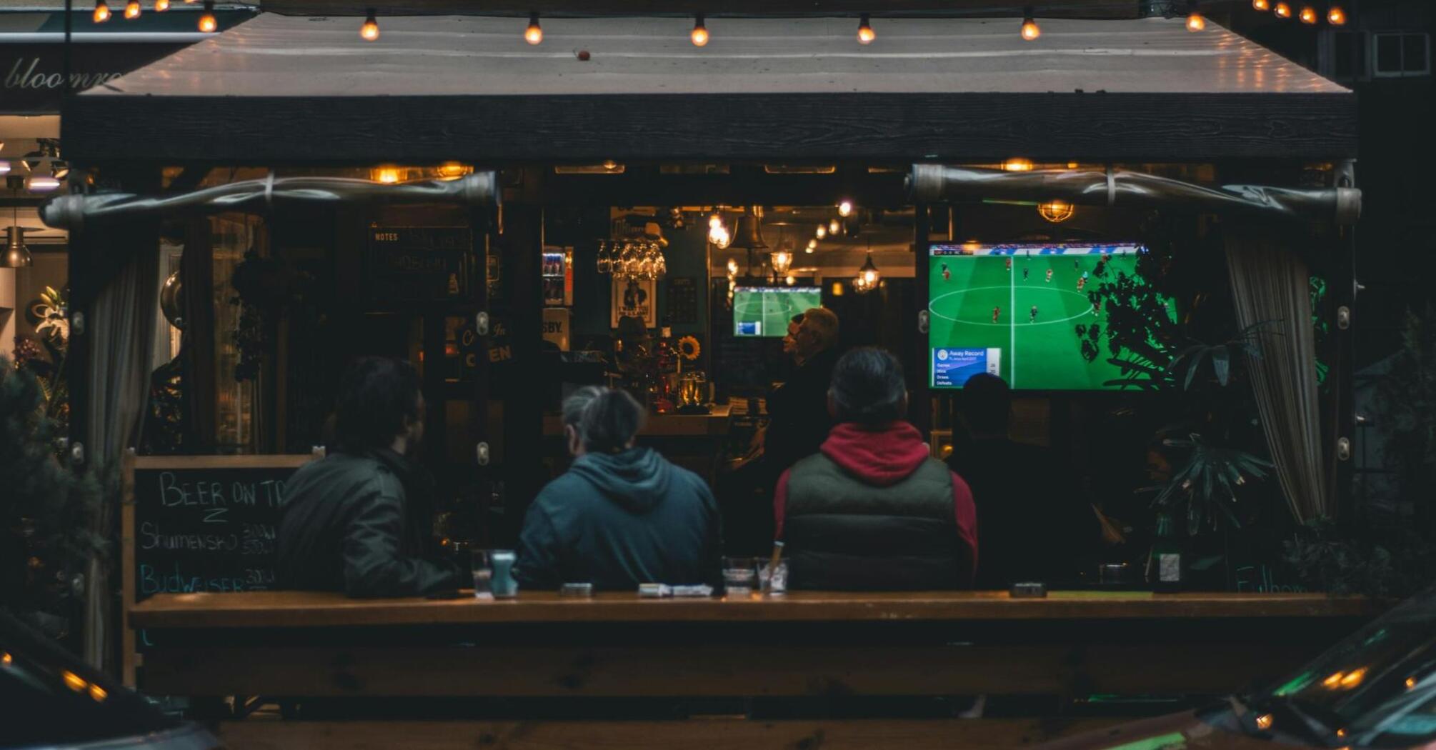 People watching a football game at a local pub