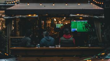 People watching a football game at a local pub