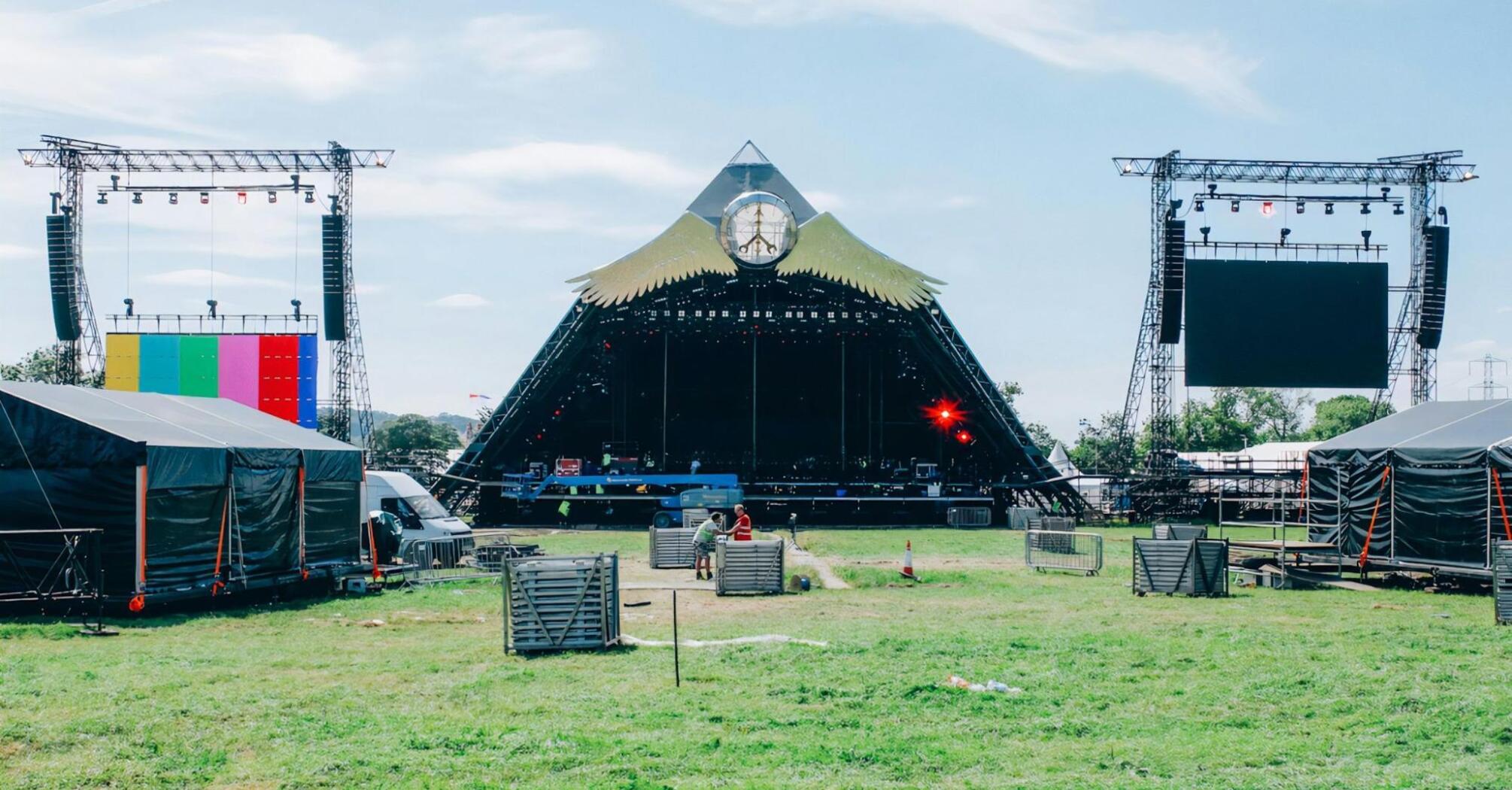 Empty Glastonbury Festival stage setup on a sunny day
