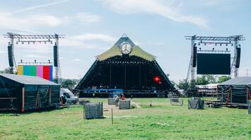 Empty Glastonbury Festival stage setup on a sunny day