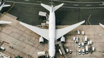 white and blue airplane on airport during daytime
