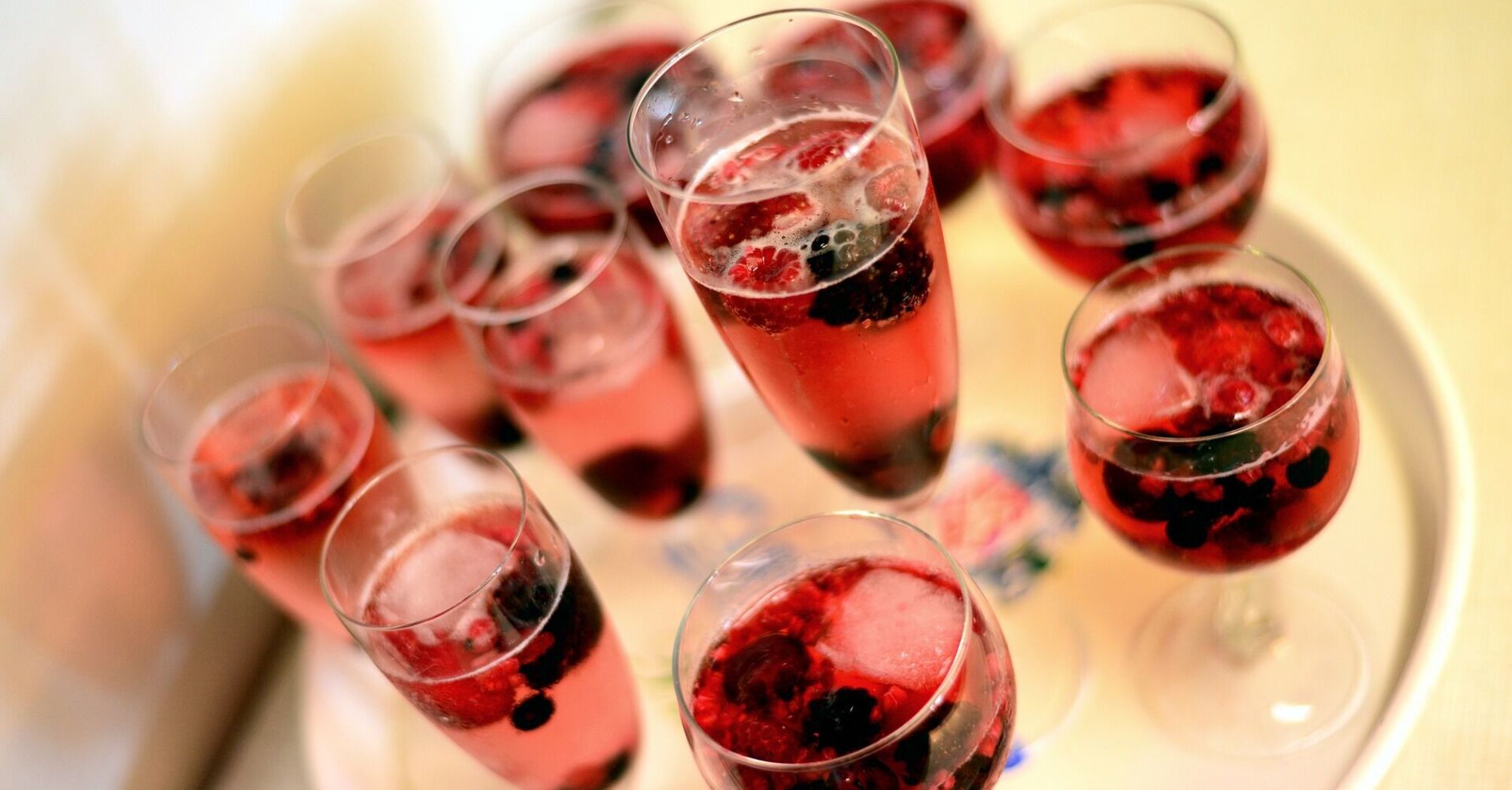 Glasses of red berry drinks on a tray