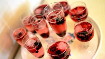 Glasses of red berry drinks on a tray