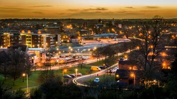 Evening view of Norwich cityscape with illuminated buildings and streets
