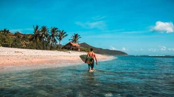 Surfer at the point break off of Lombok island in Indonesia