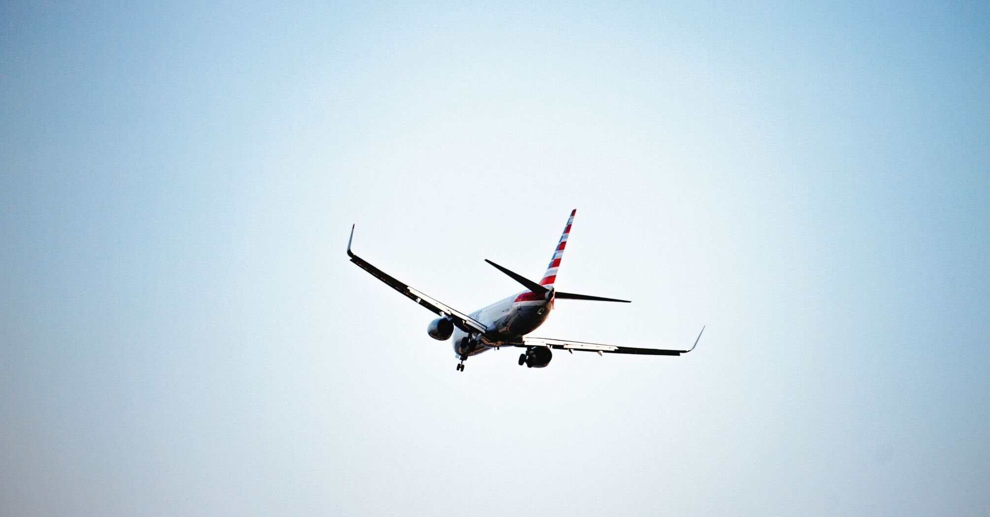 white American Airlines airplane in flight