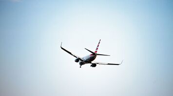 white American Airlines airplane in flight