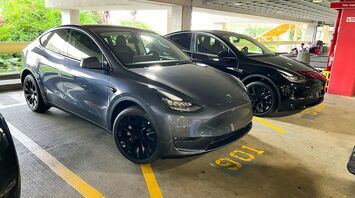 Tesla vehicles parked in a rental car lot