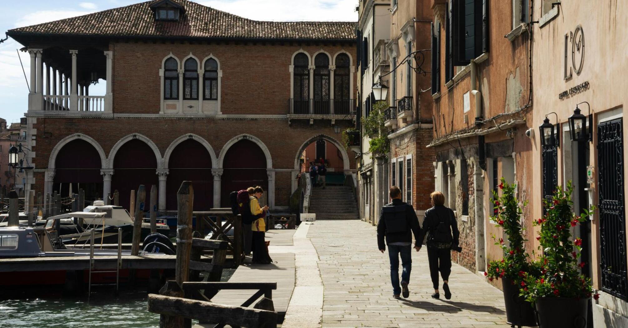 Walking couple on the street of Vinice, Italy