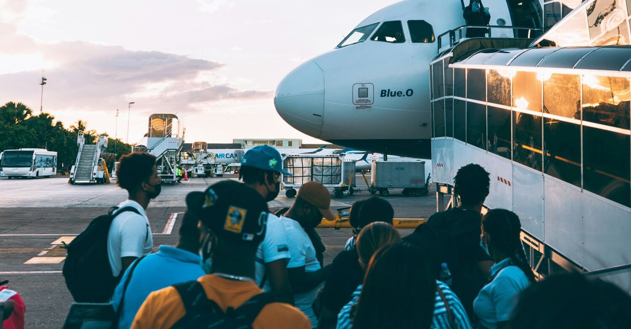 Passengers boarding a JetBlue aircraft at the airport