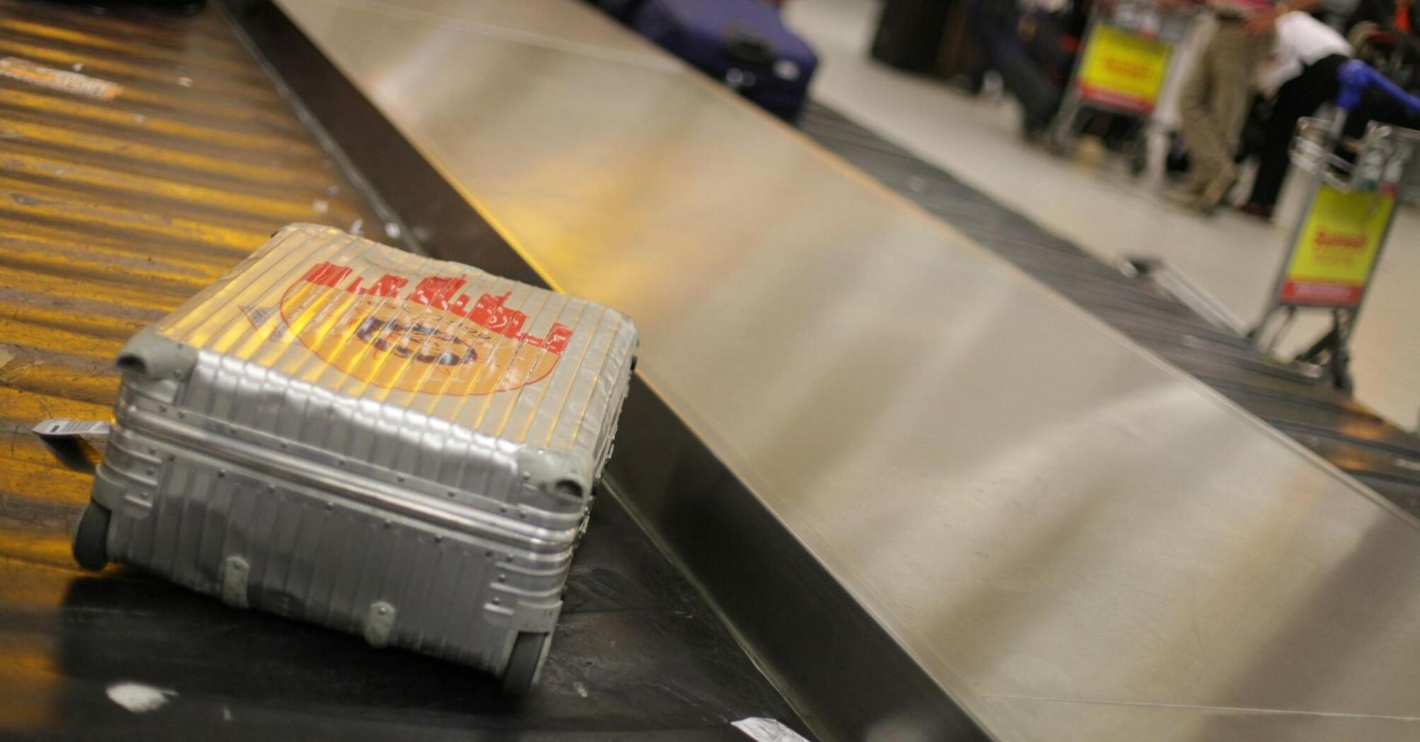 A suitcase on the baggage carousel at the airport, waiting for its owner