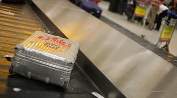 A suitcase on the baggage carousel at the airport, waiting for its owner