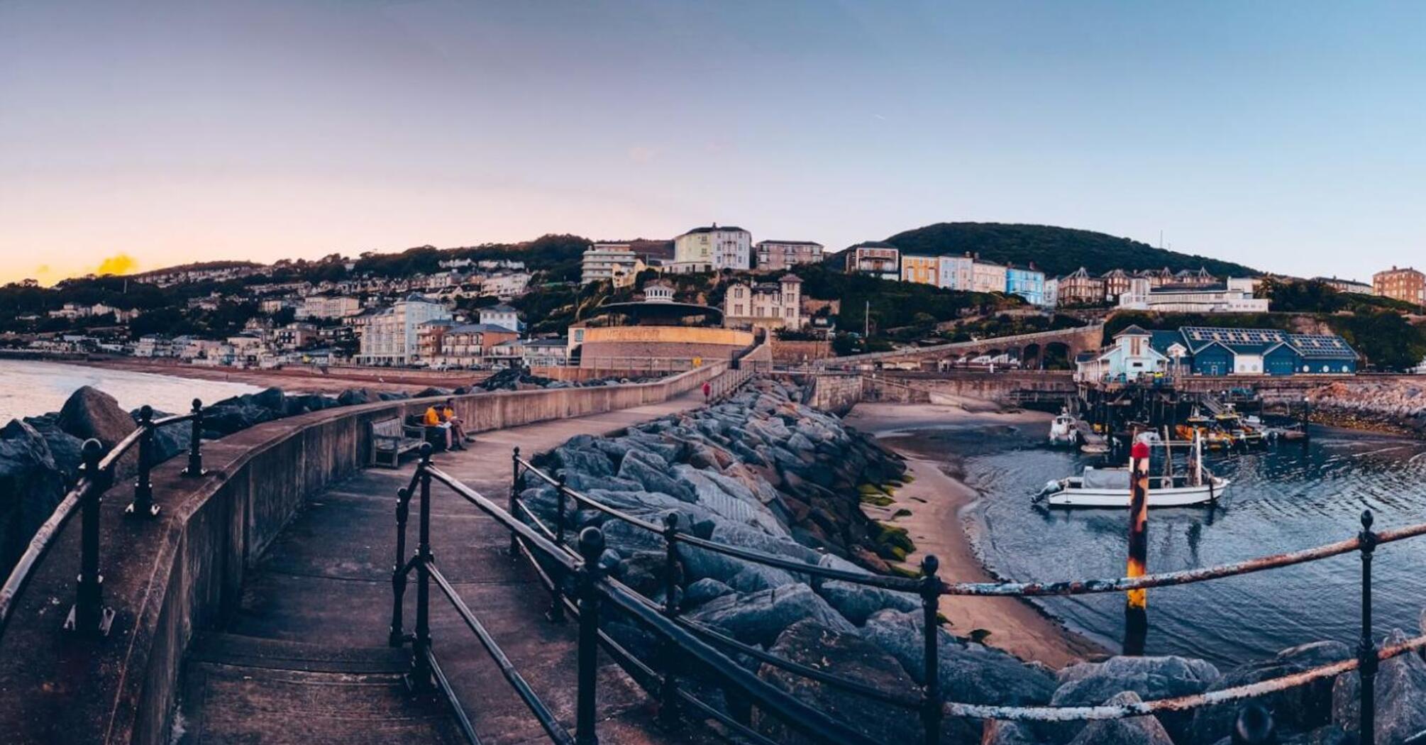 Scenic view of Ventnor Town with a coastal walkway at sunset