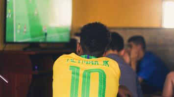 Man watching a football match on TV