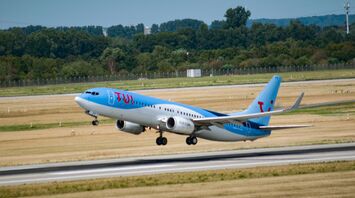 white and blue passenger plane on airport during daytime