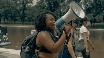 Protesters with megaphones and signs during a demonstration