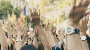 Crowd with raised hands during a protest in Spain