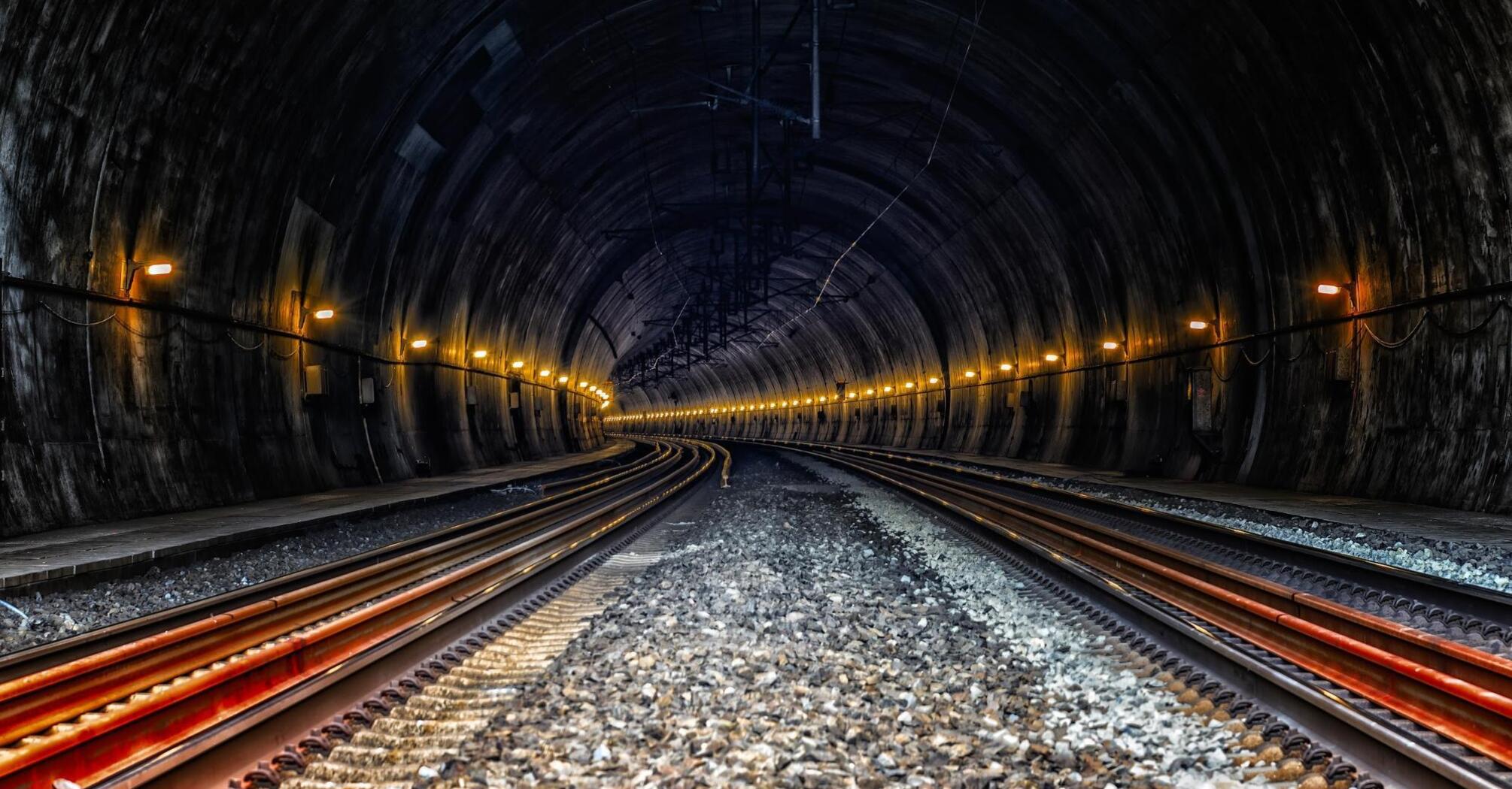 Railway tunnel with underground tracks and engineering communications