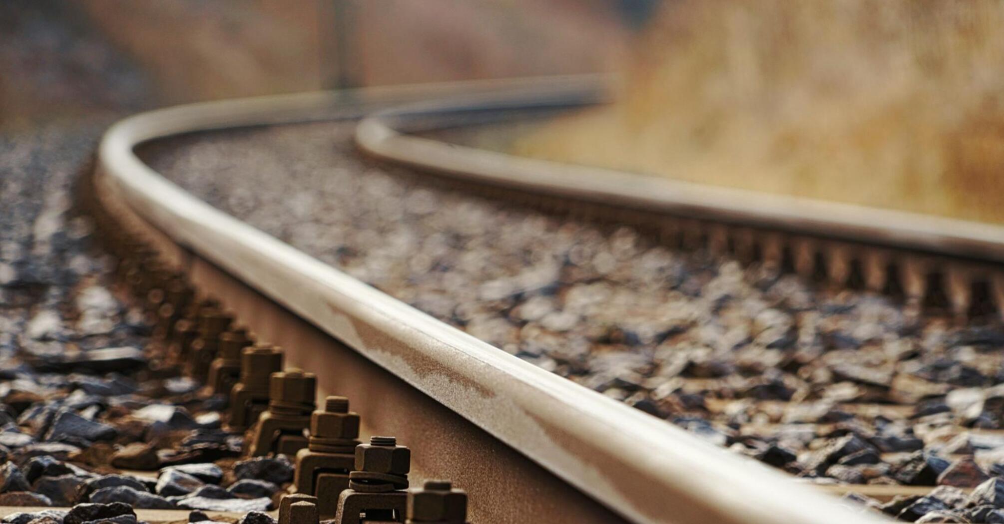 Close-up of a railway track with bolts and gravel