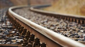 Close-up of a railway track with bolts and gravel