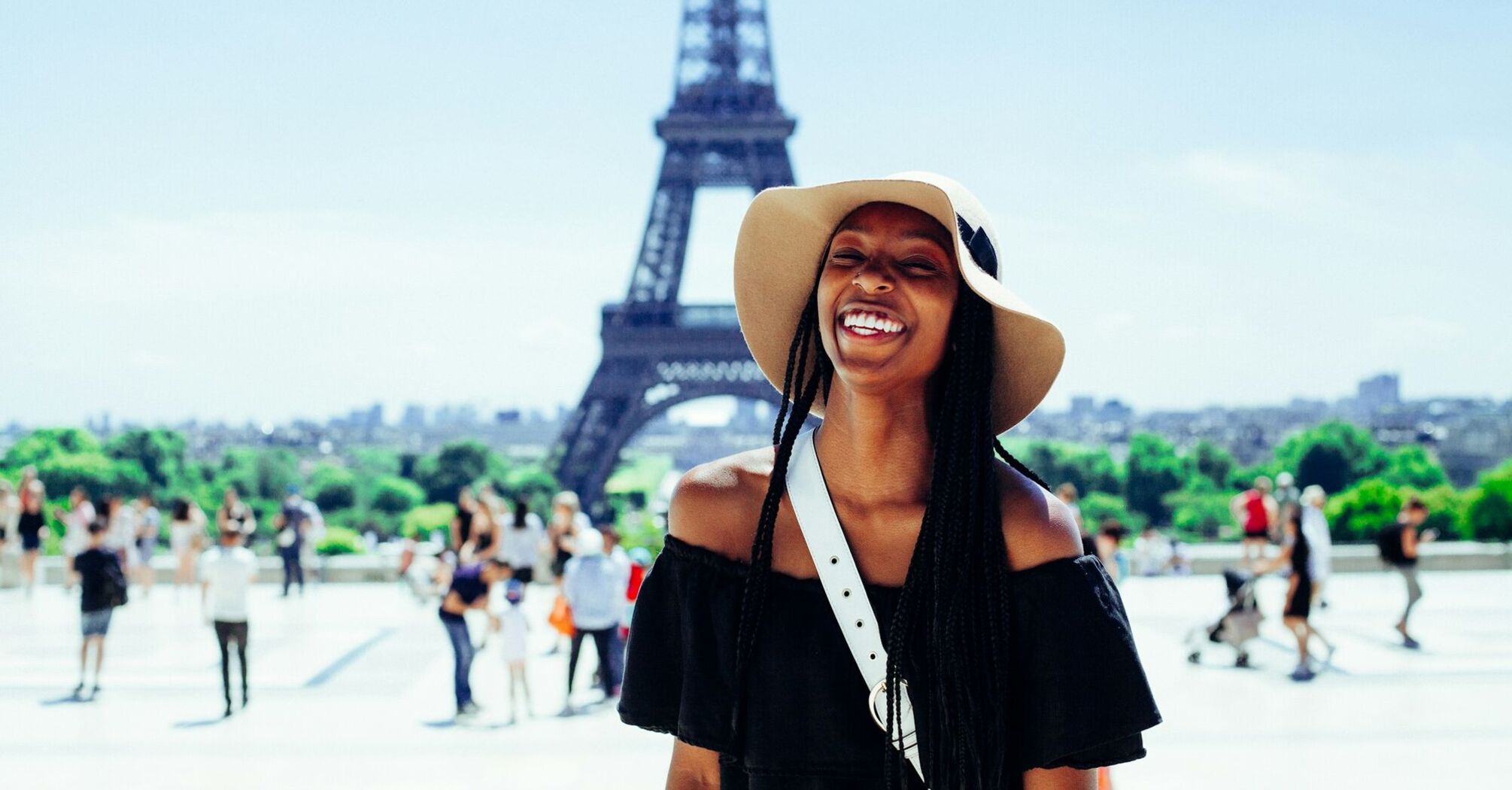 Smiling woman in front of the Eiffel Tower