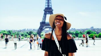 Smiling woman in front of the Eiffel Tower