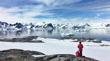 Two people watching the wonderful landscape of Antarctica