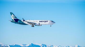 WestJet plane flying in the sky