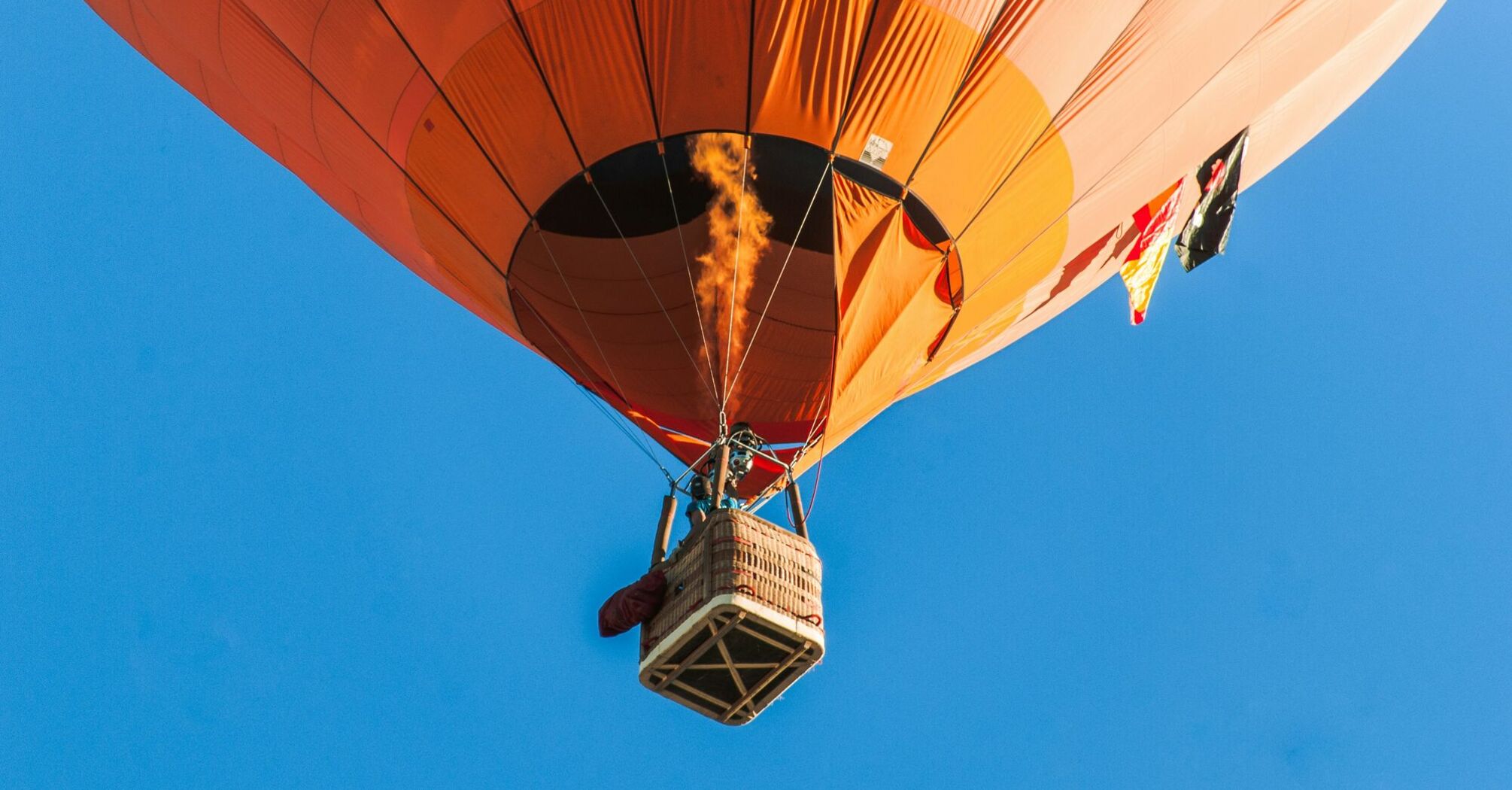 person riding a orange hot air balloon