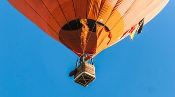 person riding a orange hot air balloon